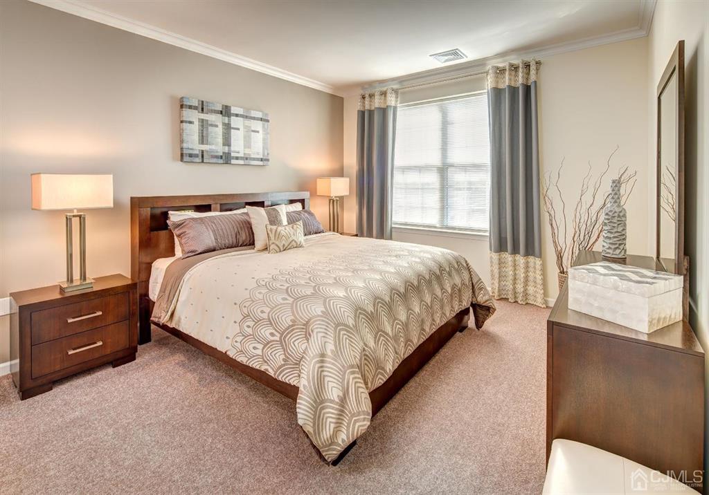 125 West Main Street, Unit 321 Somerville, NJ 08876 - Photo 14 of 17 a bedroom with a bed and a night stand