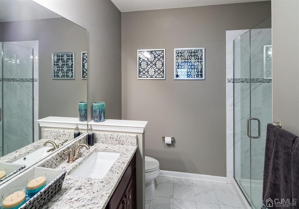 125 West Main Street, Unit 321 Somerville, NJ 08876 - Photo 15 of 17 a bathroom with a granite countertop sink a toilet and shower