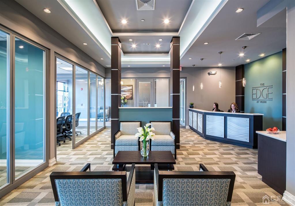 125 West Main Street, Unit 321 Somerville, NJ 08876 - Photo 3 of 17 a living room with couches and kitchen view with wooden floor