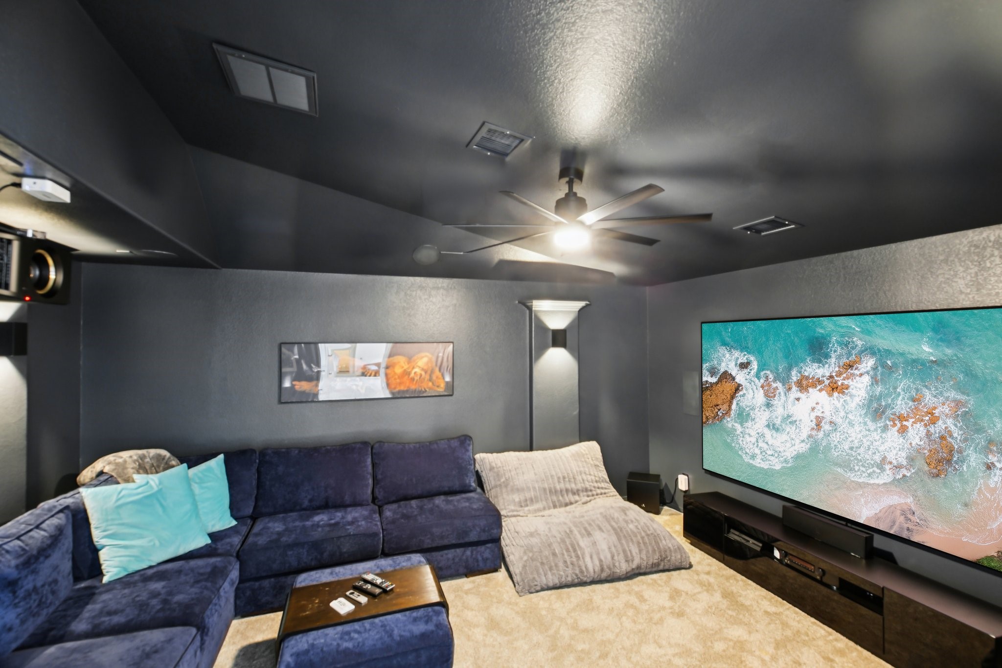 27914 Arden Trail Spring, TX 77386 - Photo 39 of 49 Dedicated media room designed for an immersive entertainment experience. Features dark walls and ceiling, recessed lighting, and a modern ceiling fan.
