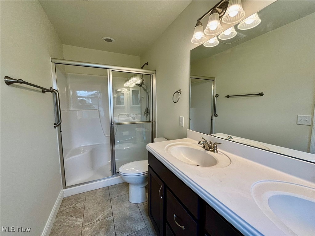 1132 Hummingbird Way Findlay, OH 45840 - Photo 17 of 28 Bathroom with double vanity and a stall shower