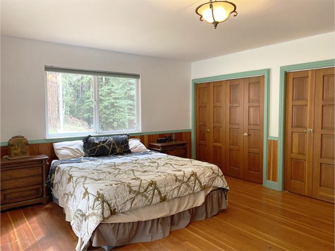 1800 Tucker Road Scotts Valley, CA 95066 - Photo 29 of 33 a bedroom with a bed and wooden floor