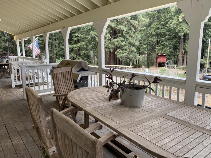 1800 Tucker Road Scotts Valley, CA 95066 - Photo 3 of 33 a view of a roof deck with table and chairs couches with wooden floor and fence