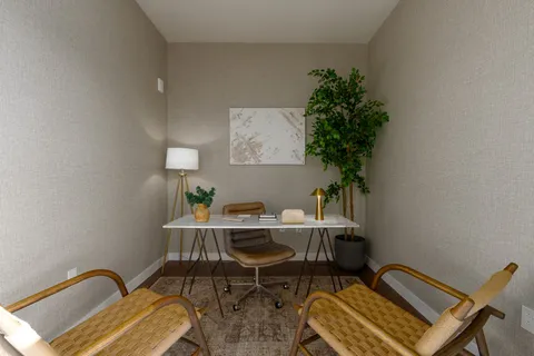 a large bed sitting in a bedroom next to a lamp