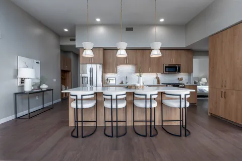a kitchen with a table chairs and a refrigerator