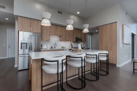 a kitchen with a stove and a wooden floor
