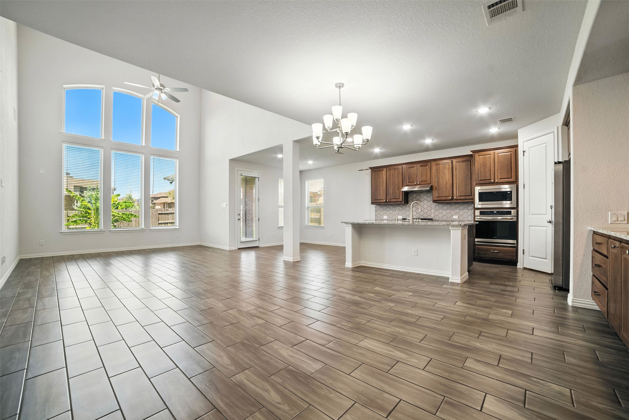 3054 Columbus Loop Round Rock, TX 78665 - Photo 37 of 40 Kitchen featuring open floor plan, backsplash, a chandelier, appliances with stainless steel finishes, and a ceiling fan