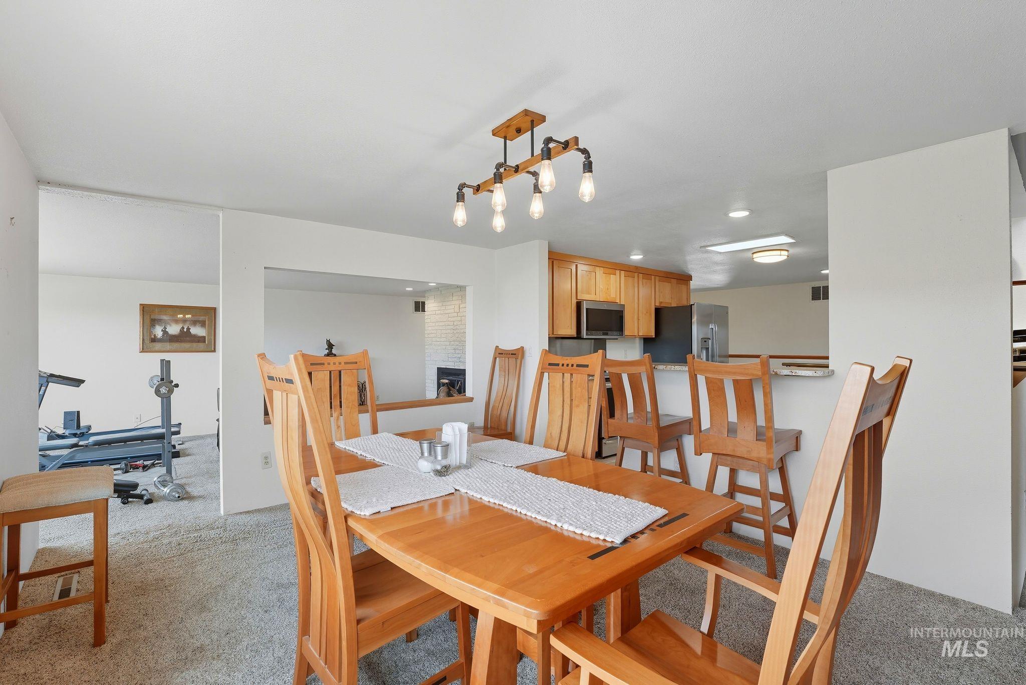 1101 5th Street Asotin, WA 99402 - Photo 11 of 48 Dining room with light carpet and a brick fireplace