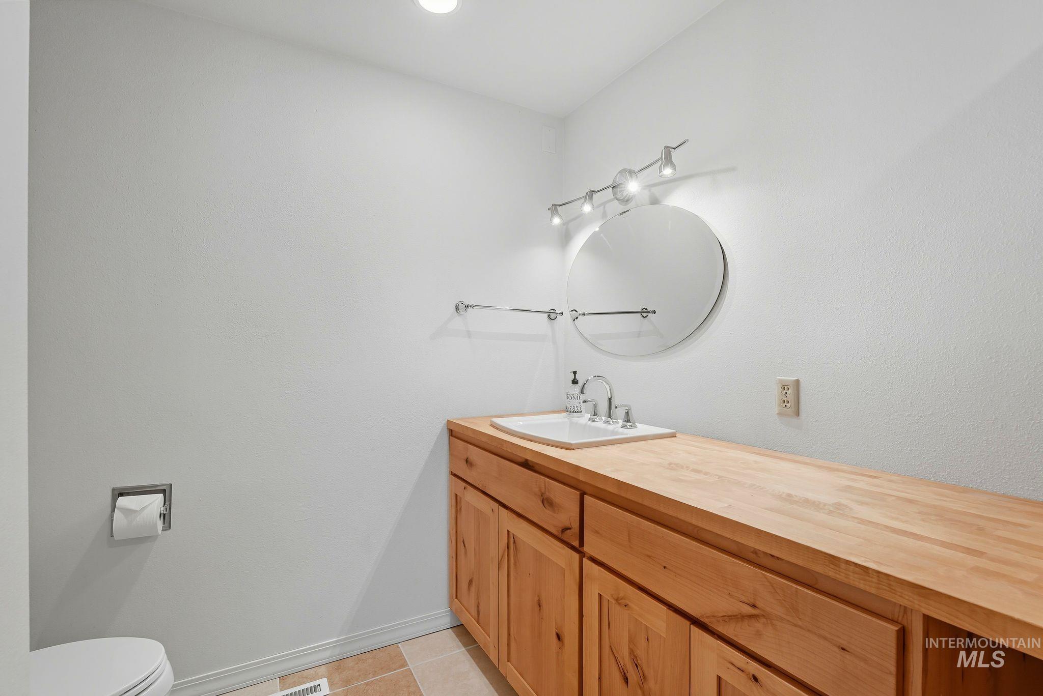 1101 5th Street Asotin, WA 99402 - Photo 18 of 48 Half bathroom with vanity and light tile patterned floors