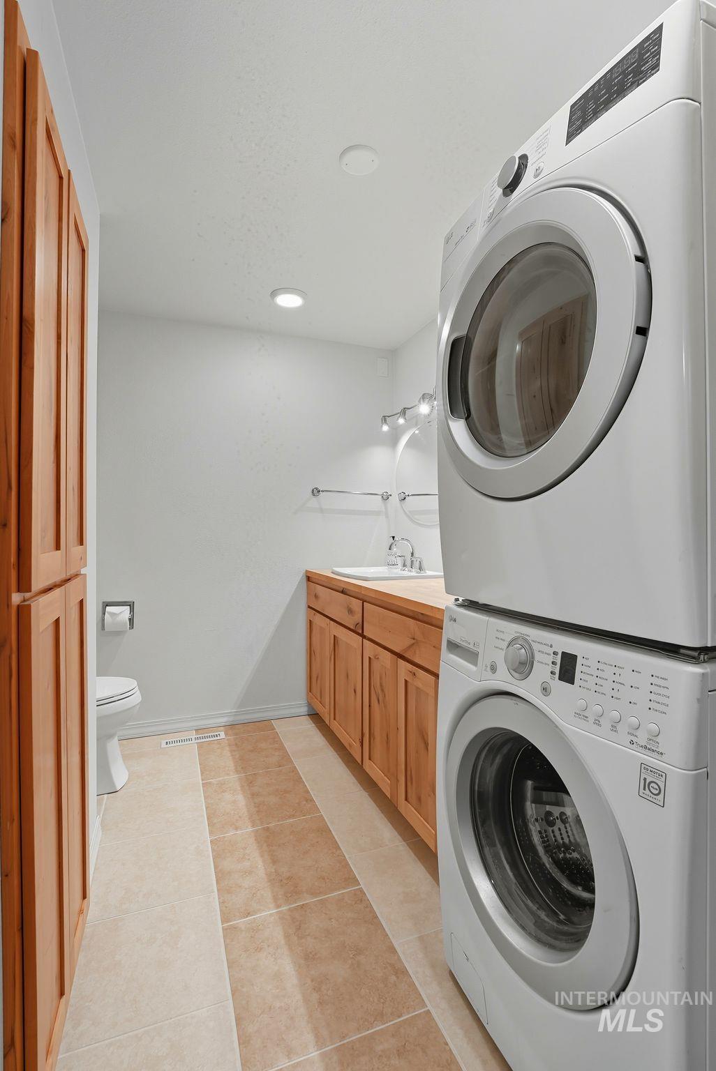 1101 5th Street Asotin, WA 99402 - Photo 18 of 48 Washroom featuring light tile patterned floors, estacked washer and dryer, and recessed lighting
