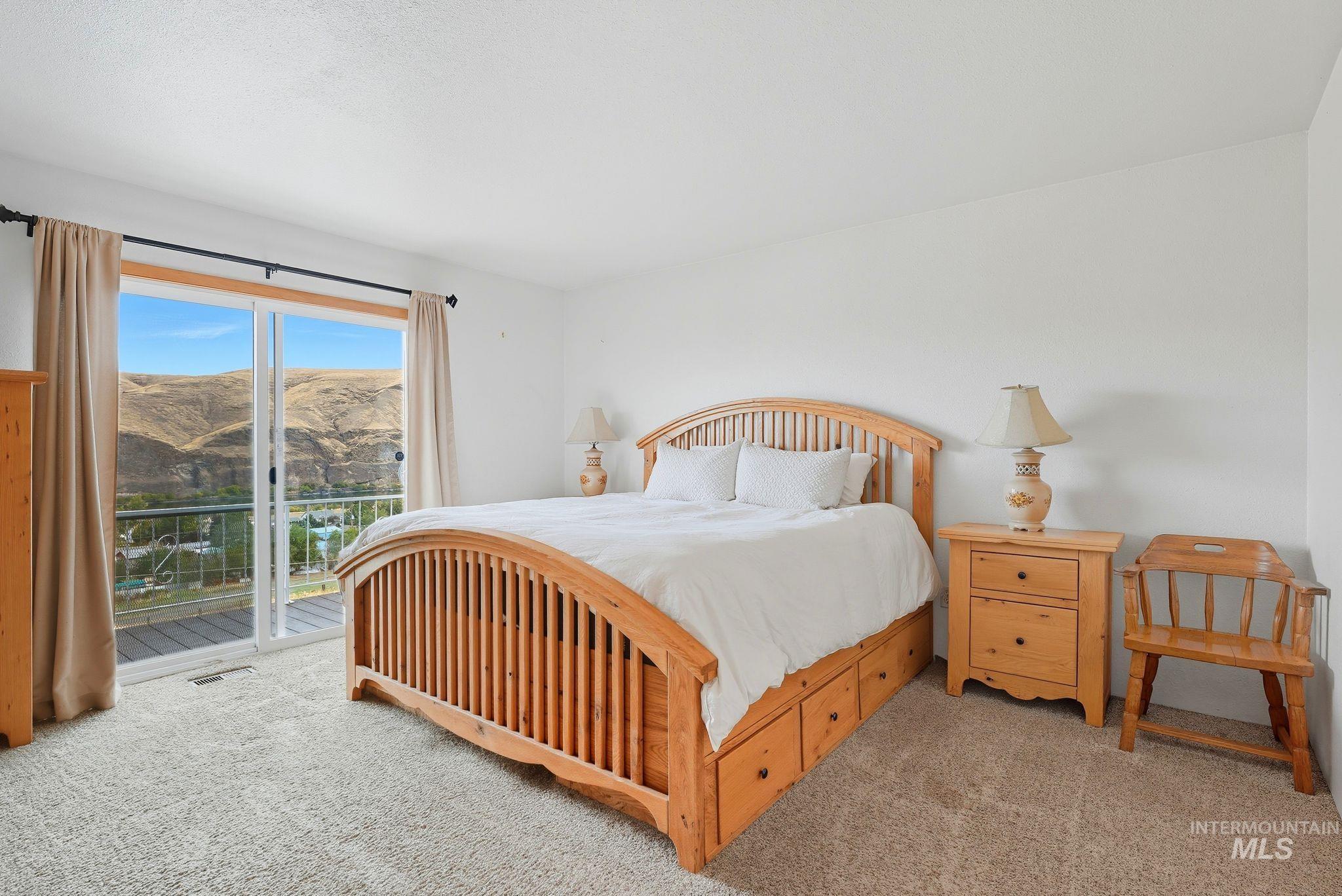 1101 5th Street Asotin, WA 99402 - Photo 19 of 48 Carpeted bedroom featuring a mountain view and access to outside