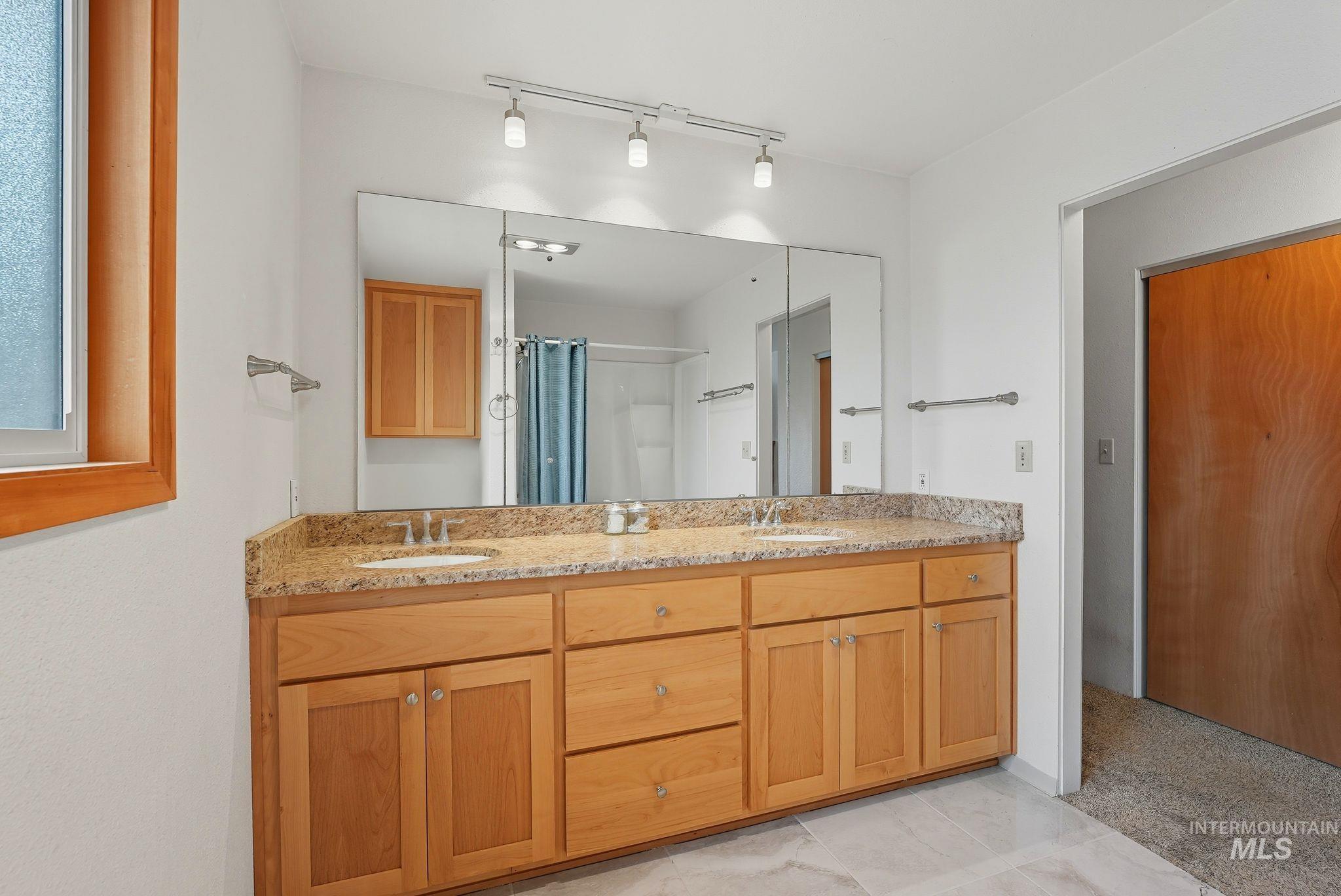 1101 5th Street Asotin, WA 99402 - Photo 27 of 48 Full bathroom with double vanity, light tile patterned floors, and a shower with curtain
