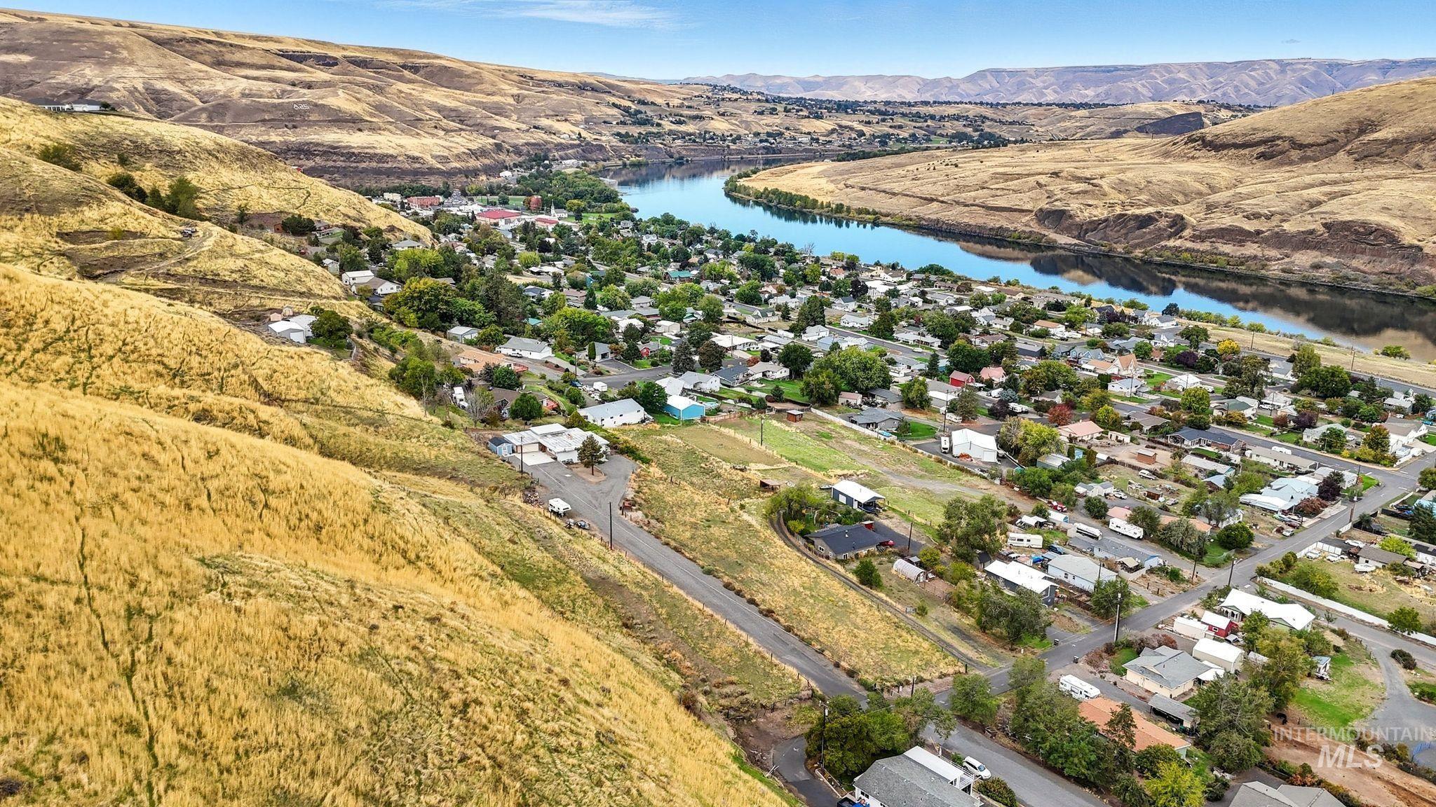 1101 5th Street Asotin, WA 99402 - Photo 5 of 48 Aerial view of property and surrounding area featuring a water and mountain view and nearby suburban area