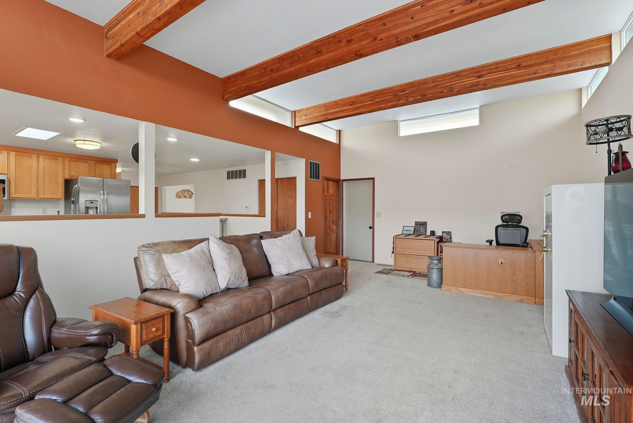1101 5th Street Asotin, WA 99402 - Photo 9 of 48 Living area with beam ceiling, light colored carpet, and a desk
