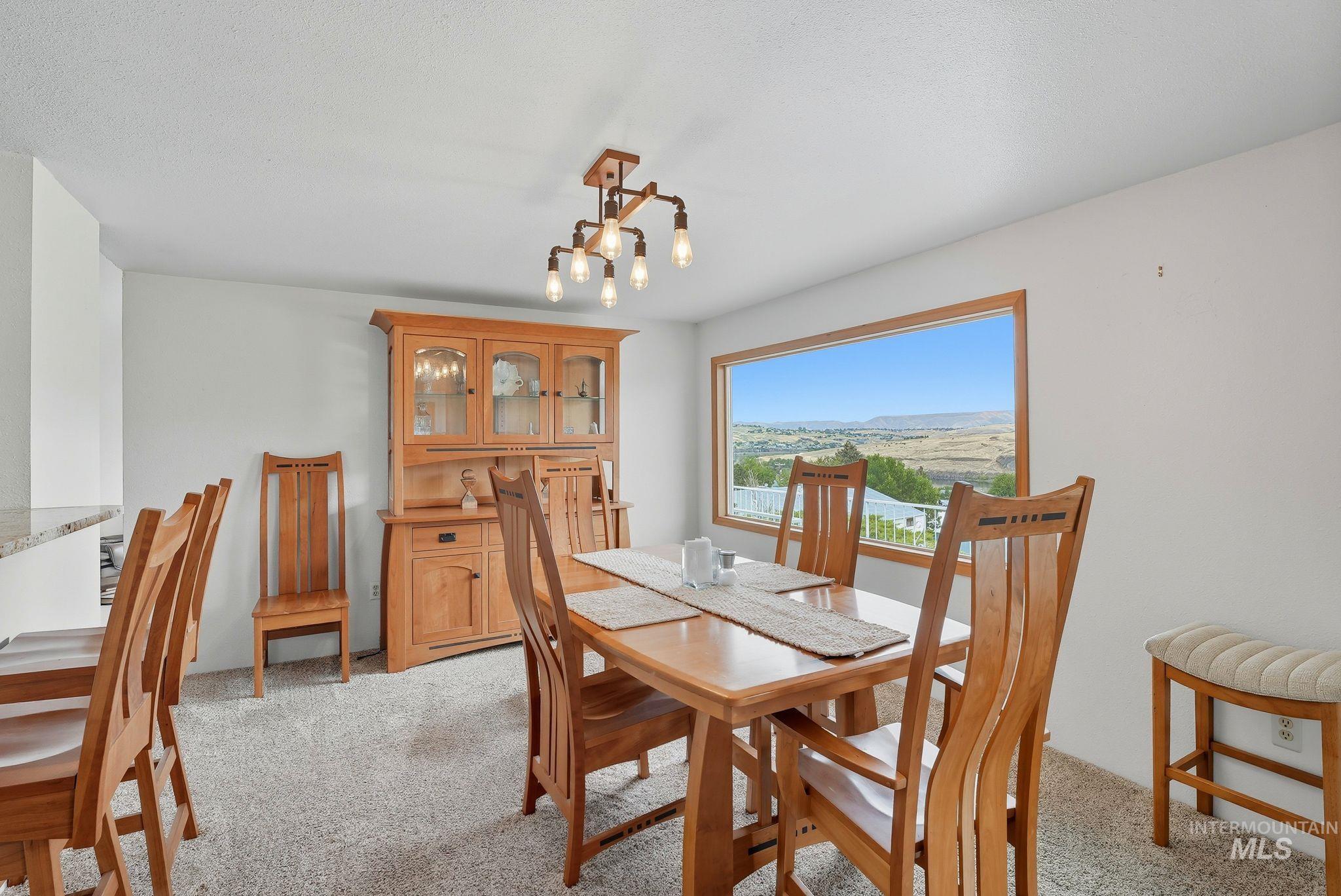 1101 5th Street Asotin, WA 99402 - Photo 10 of 48 Dining area with light carpet and a chandelier