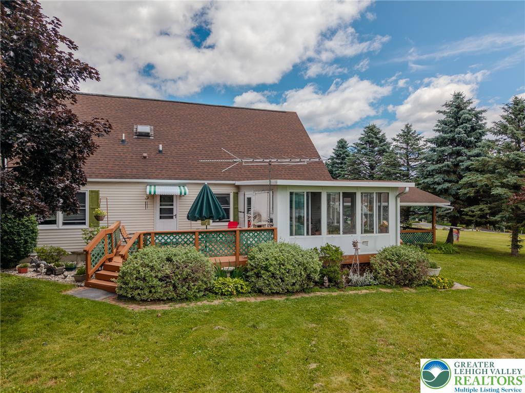 40 Locke Heights Road Bangor, PA 18013 - Photo 3 of 28 A well-maintained side exterior showcases a comfortable deck with ample outdoor living space.