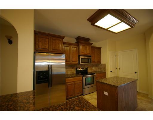 8210 Azimuth Court Corpus Christi, TX 78414 - Photo 4 of 10 a kitchen with stainless steel appliances granite countertop a refrigerator a stove and a sink