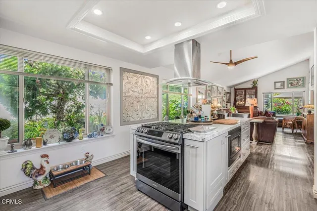 a open kitchen with stainless steel appliances granite countertop a stove and a refrigerator