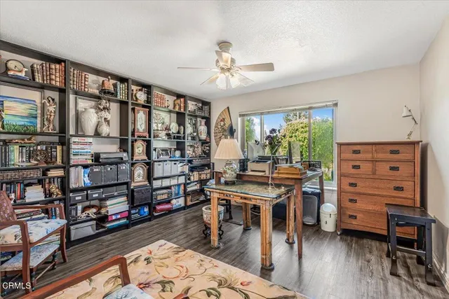 a living room with lots of furniture and a book shelf