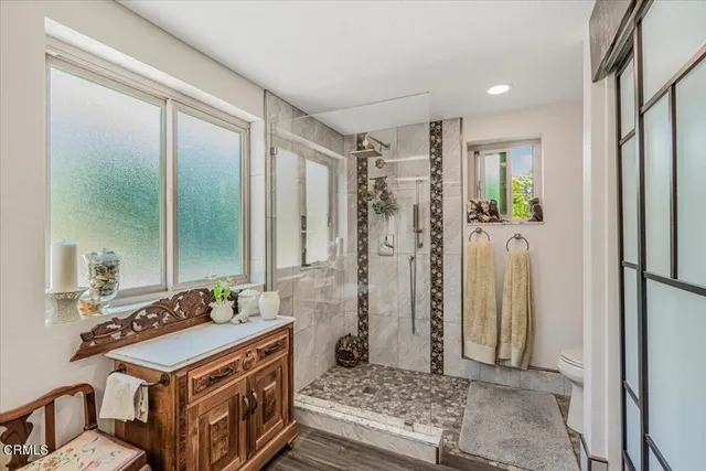 a kitchen with stainless steel appliances granite countertop a stove a refrigerator and a granite counter tops with white cabinets