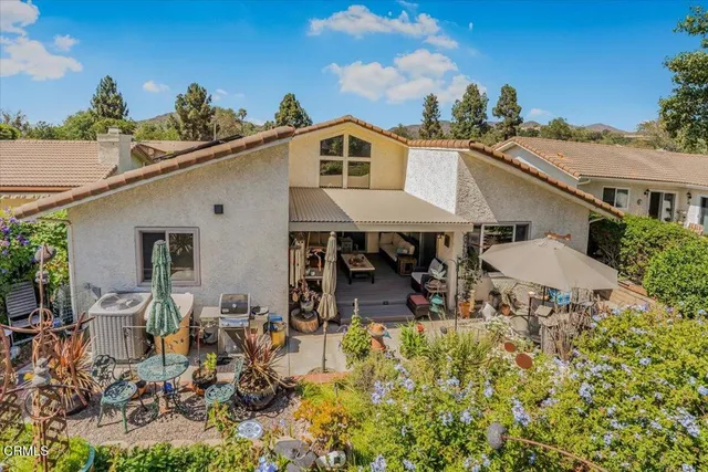 a view of a patio with table and chairs and potted plants