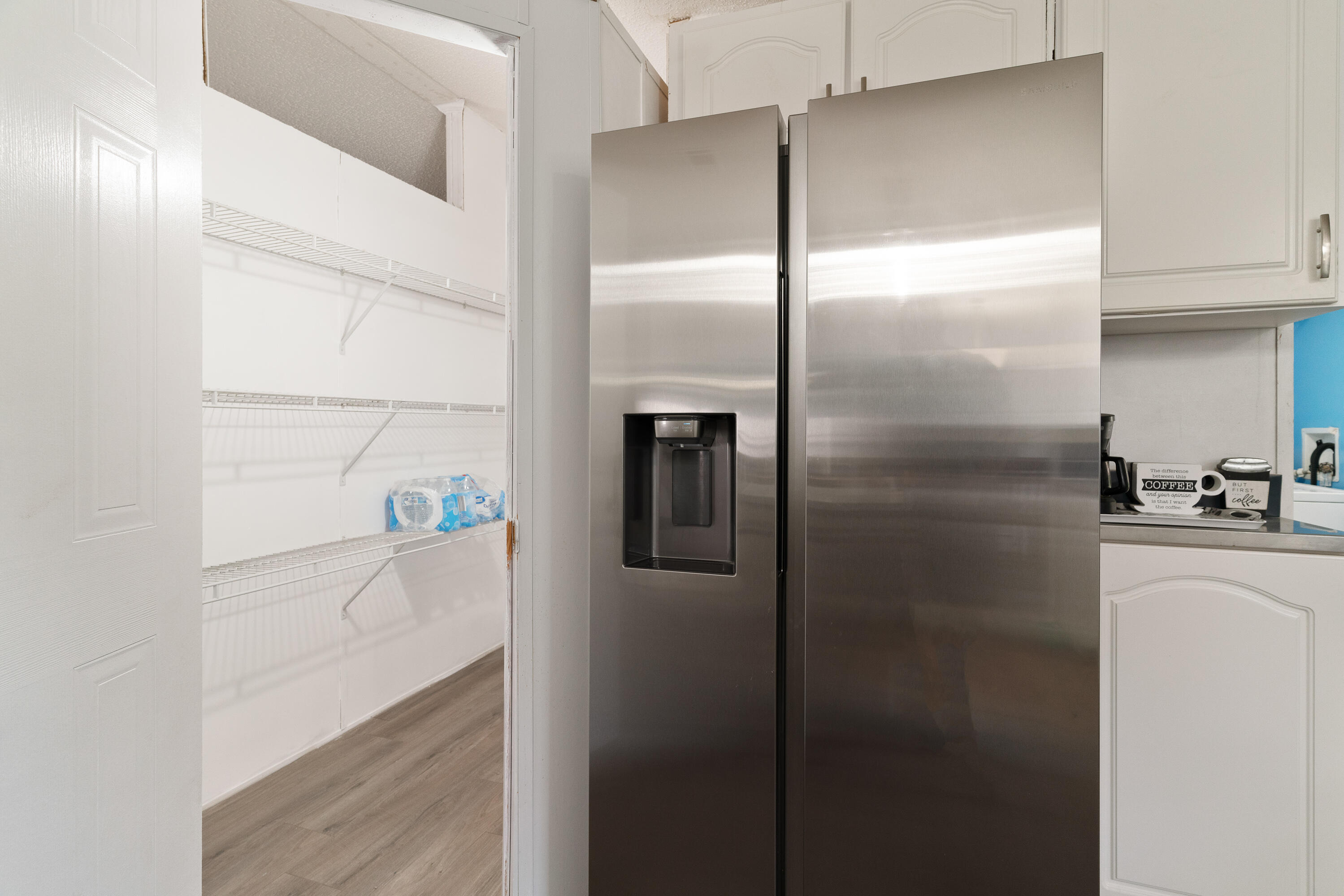 1032 Whitehead Drive Holt, FL 32564 - Photo 11 of 40 a kitchen with a refrigerator and white cabinets