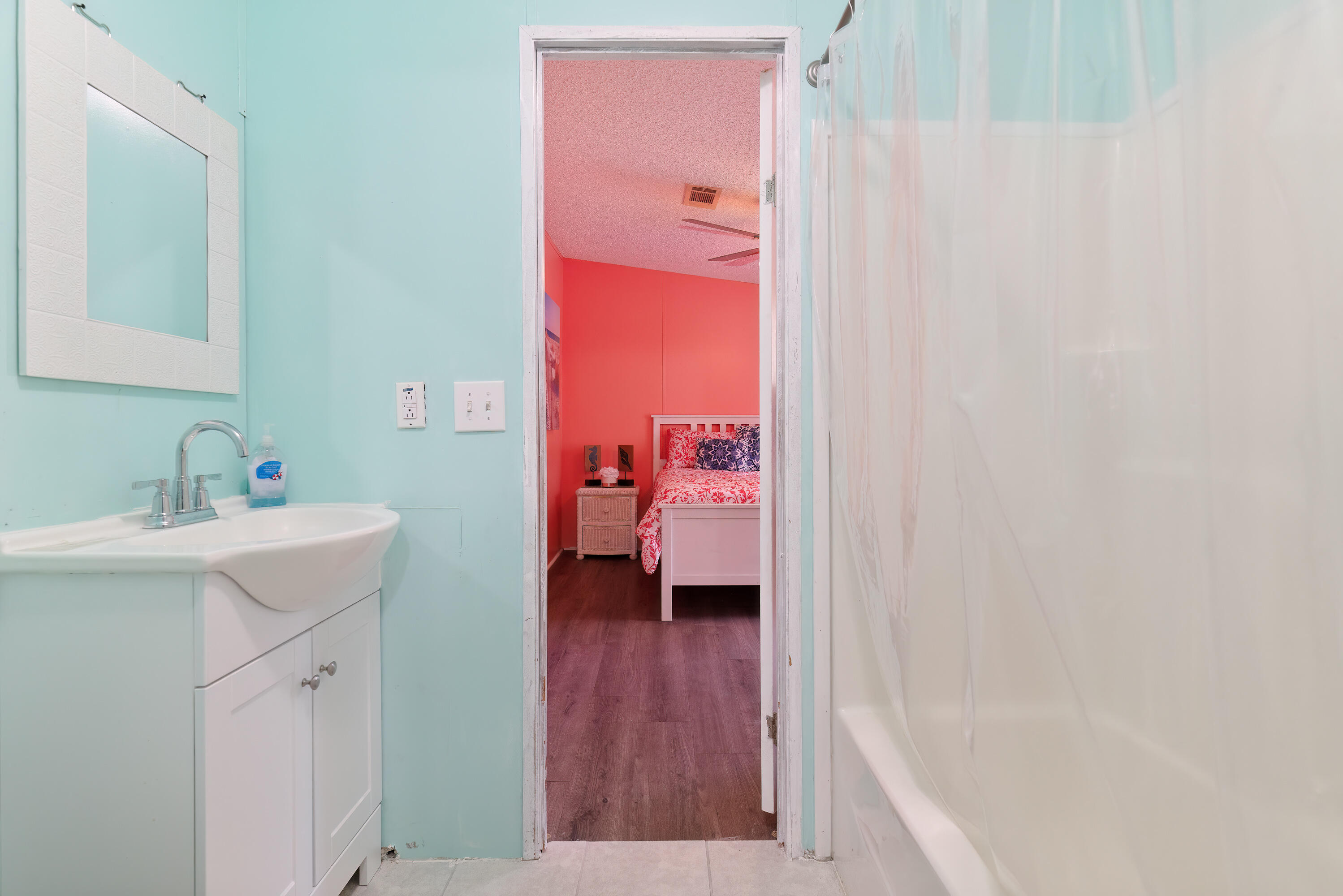 1032 Whitehead Drive Holt, FL 32564 - Photo 21 of 40 a en suite bathroom with a sink a mirror and a shower
