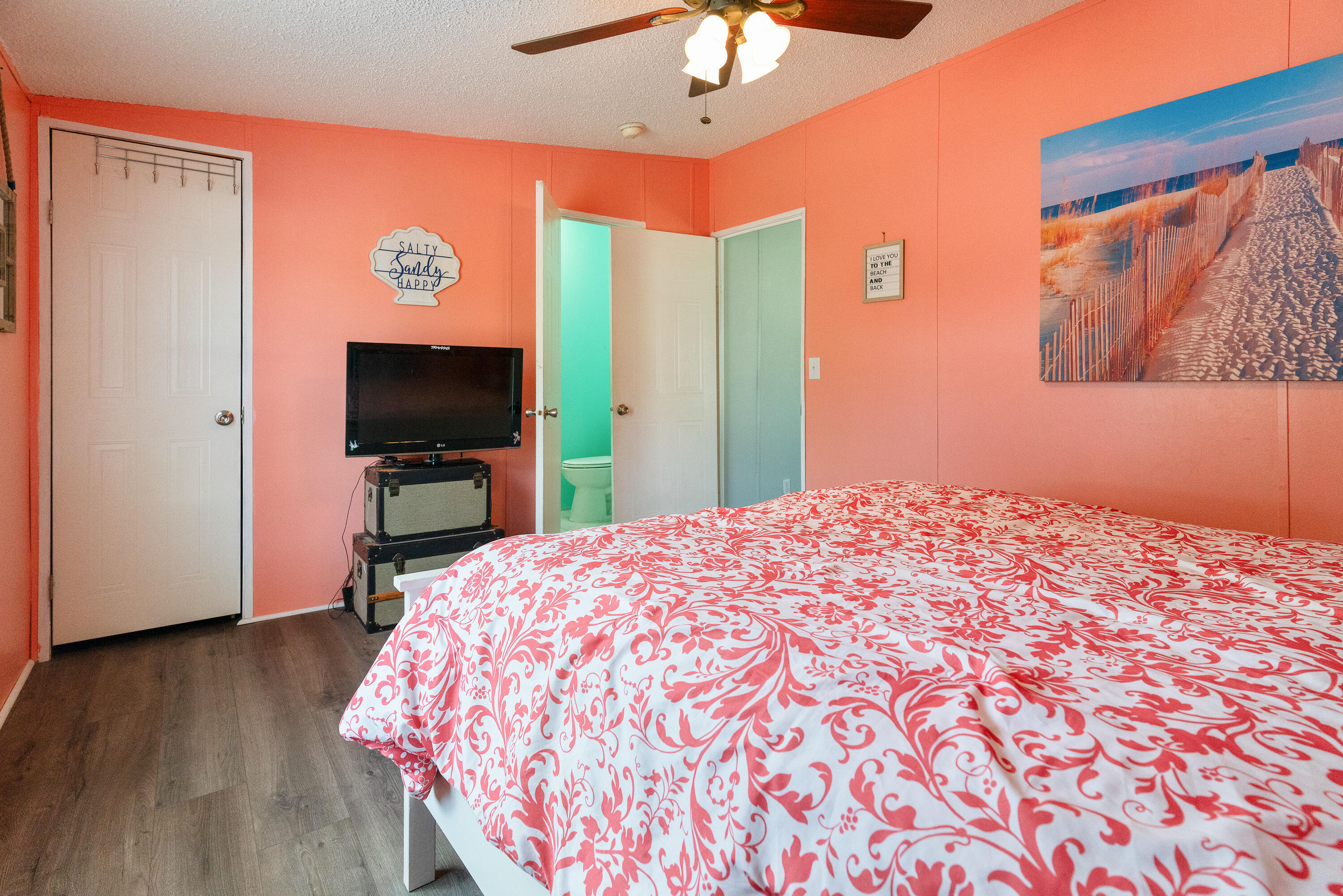 1032 Whitehead Drive Holt, FL 32564 - Photo 23 of 40 a bedroom with a bed and a flat screen tv