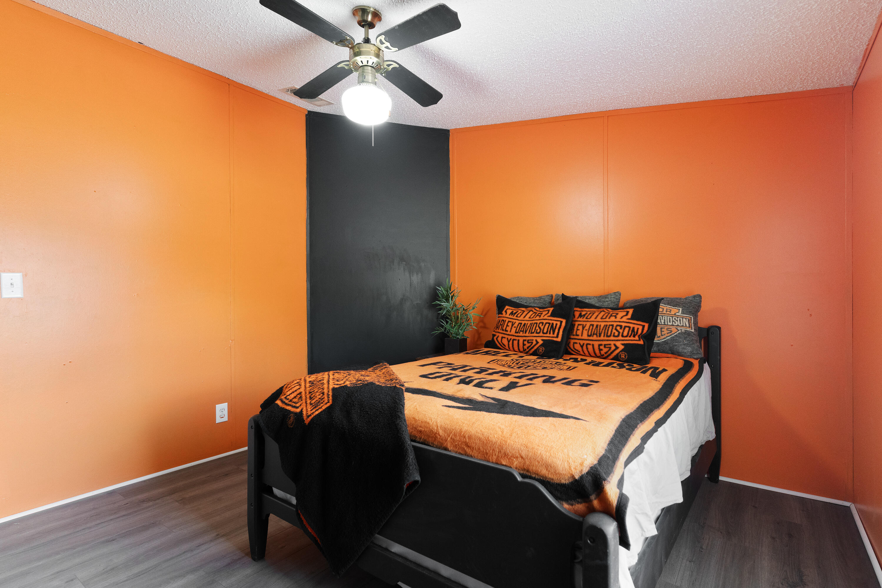 1032 Whitehead Drive Holt, FL 32564 - Photo 26 of 40 a bedroom with a bed and wooden floor