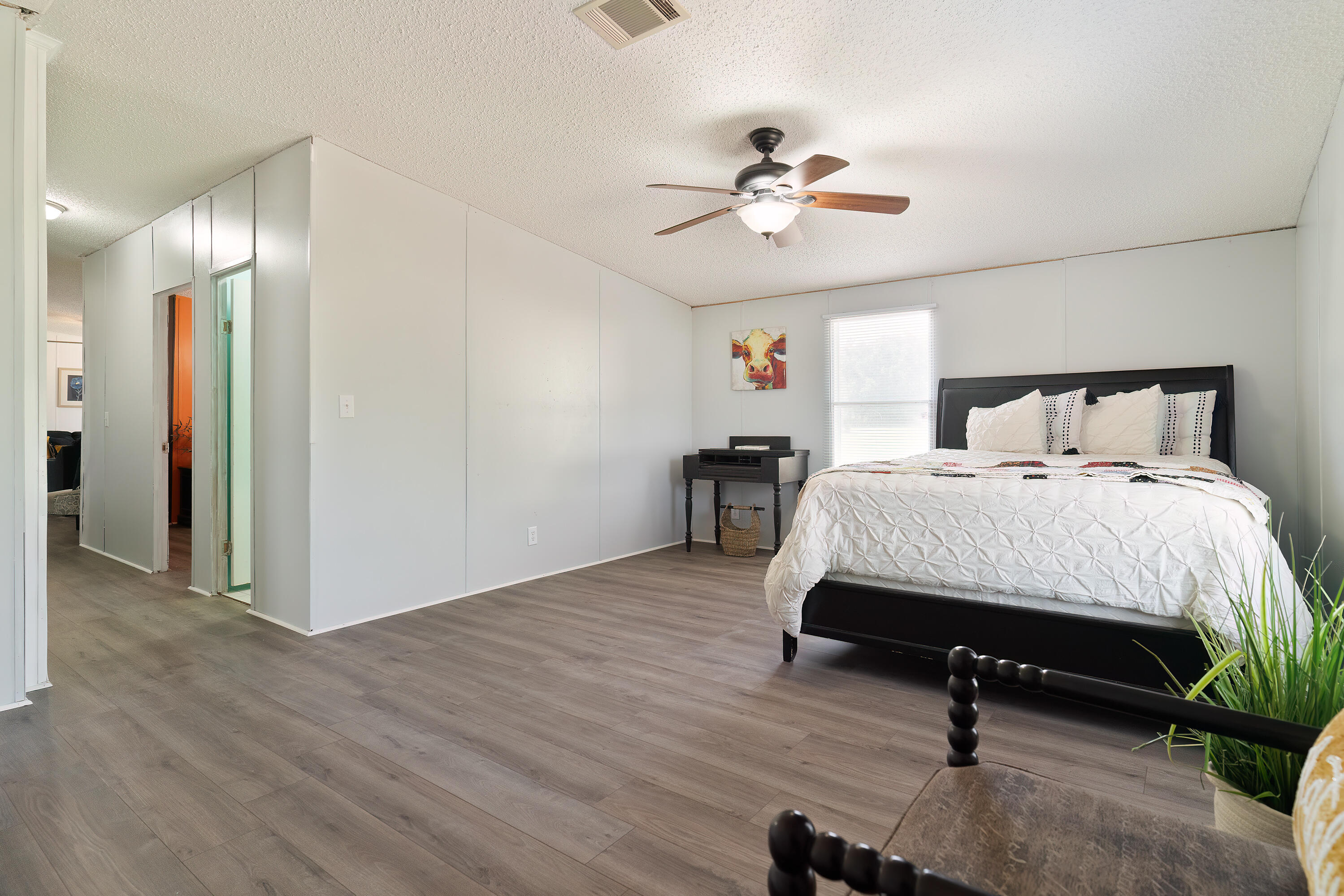 1032 Whitehead Drive Holt, FL 32564 - Photo 28 of 40 a room with a bed and a chandelier