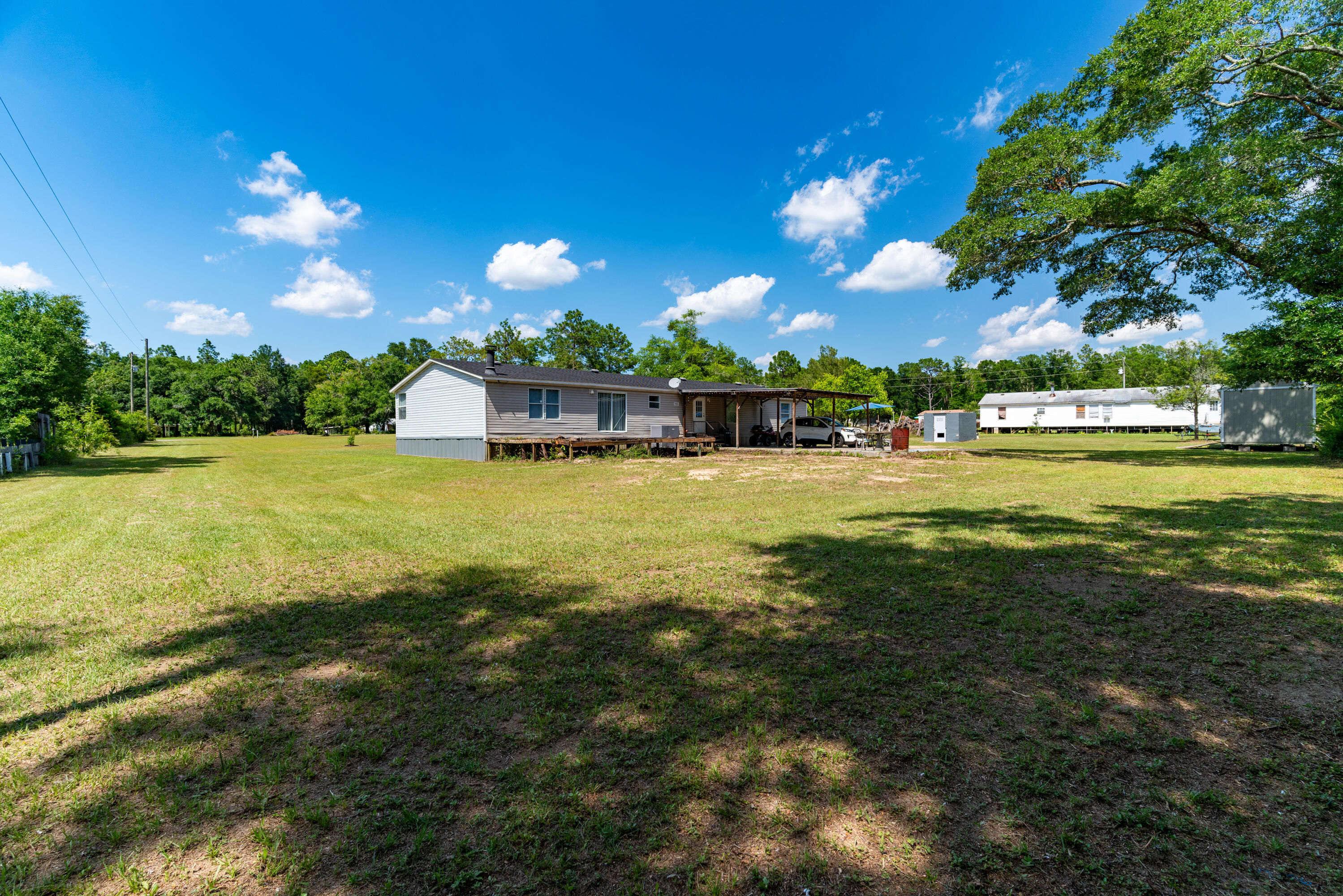 1032 Whitehead Drive Holt, FL 32564 - Photo 32 of 40 a view of a swimming pool with an outdoor seating and yard