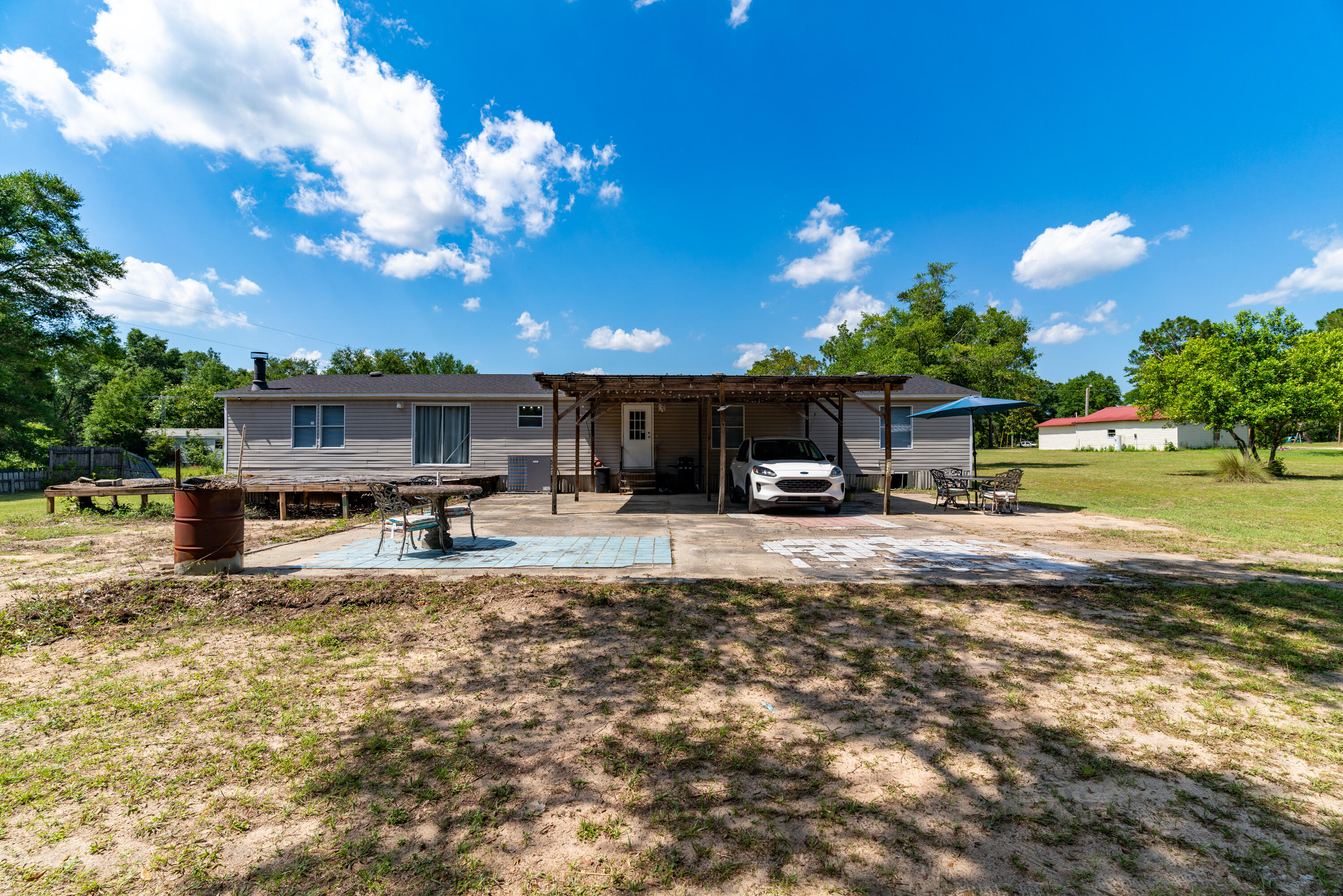 1032 Whitehead Drive Holt, FL 32564 - Photo 33 of 40 a view of a house with patio and sitting area
