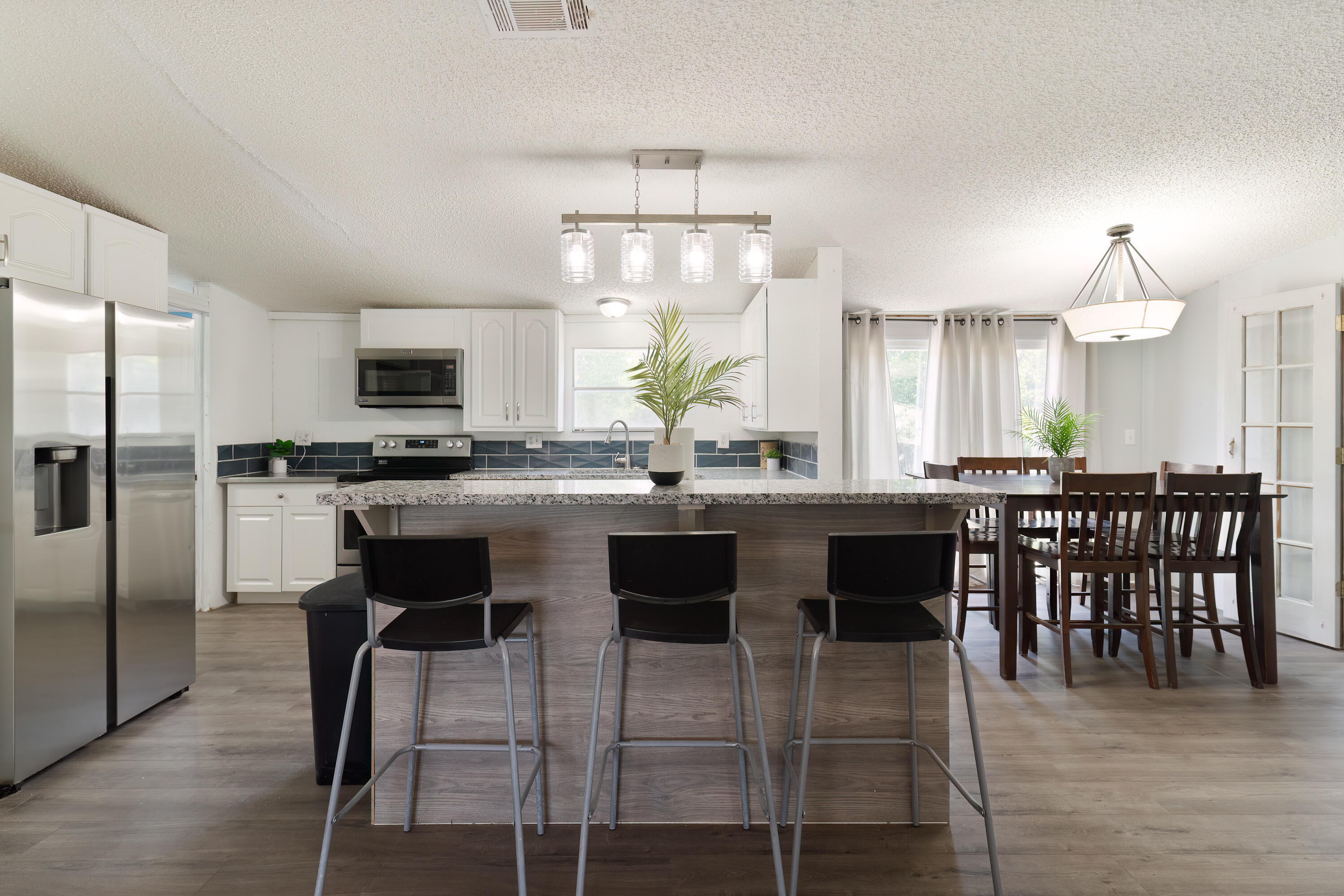 1032 Whitehead Drive Holt, FL 32564 - Photo 6 of 40 a kitchen with kitchen island granite countertop a sink and stainless steel appliances