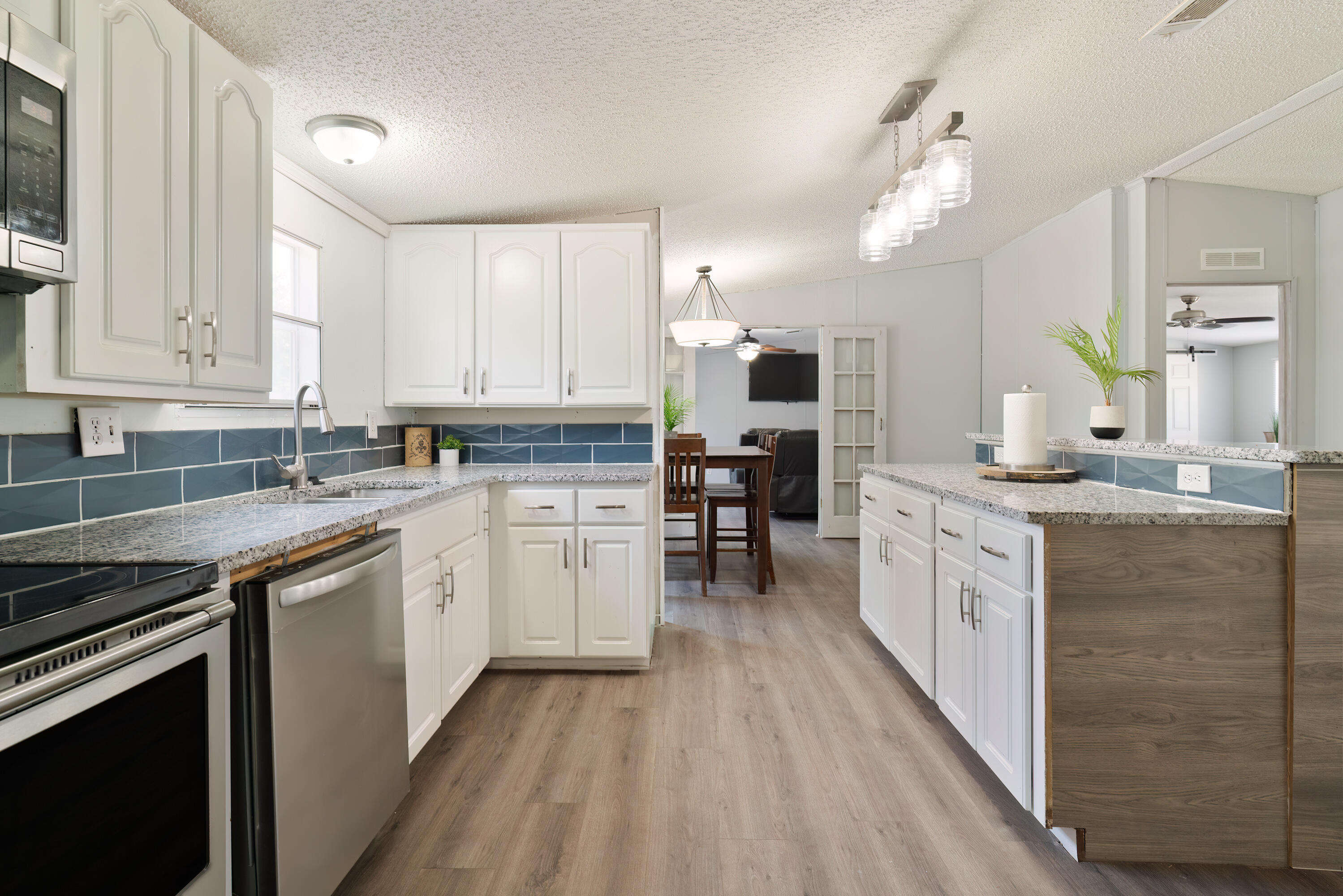 1032 Whitehead Drive Holt, FL 32564 - Photo 8 of 40 a kitchen with granite countertop white cabinets and white appliances