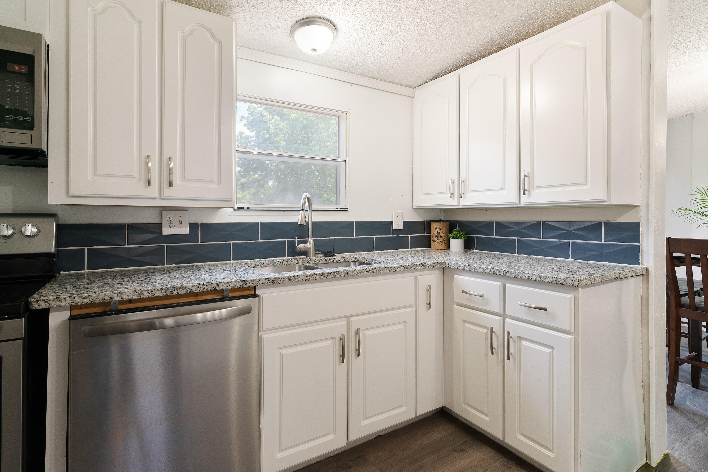 1032 Whitehead Drive Holt, FL 32564 - Photo 9 of 40 a kitchen with white cabinets and a sink