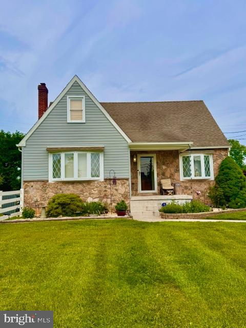 Charming home with lush green surroundings.