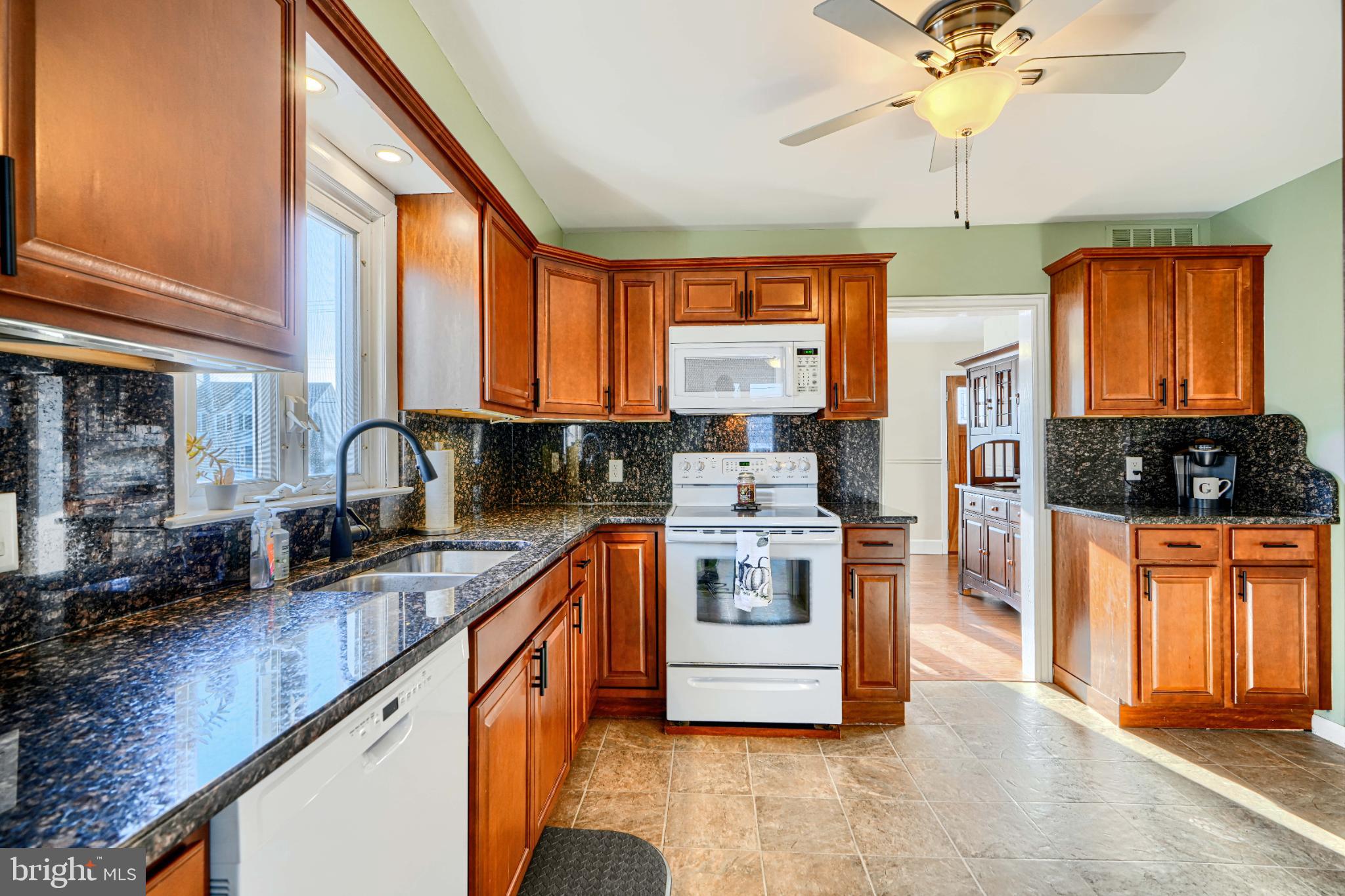 5706 Allender Road White Marsh, MD 21162 - Photo 15 of 61 a kitchen with stainless steel appliances granite countertop a stove a sink and a microwave