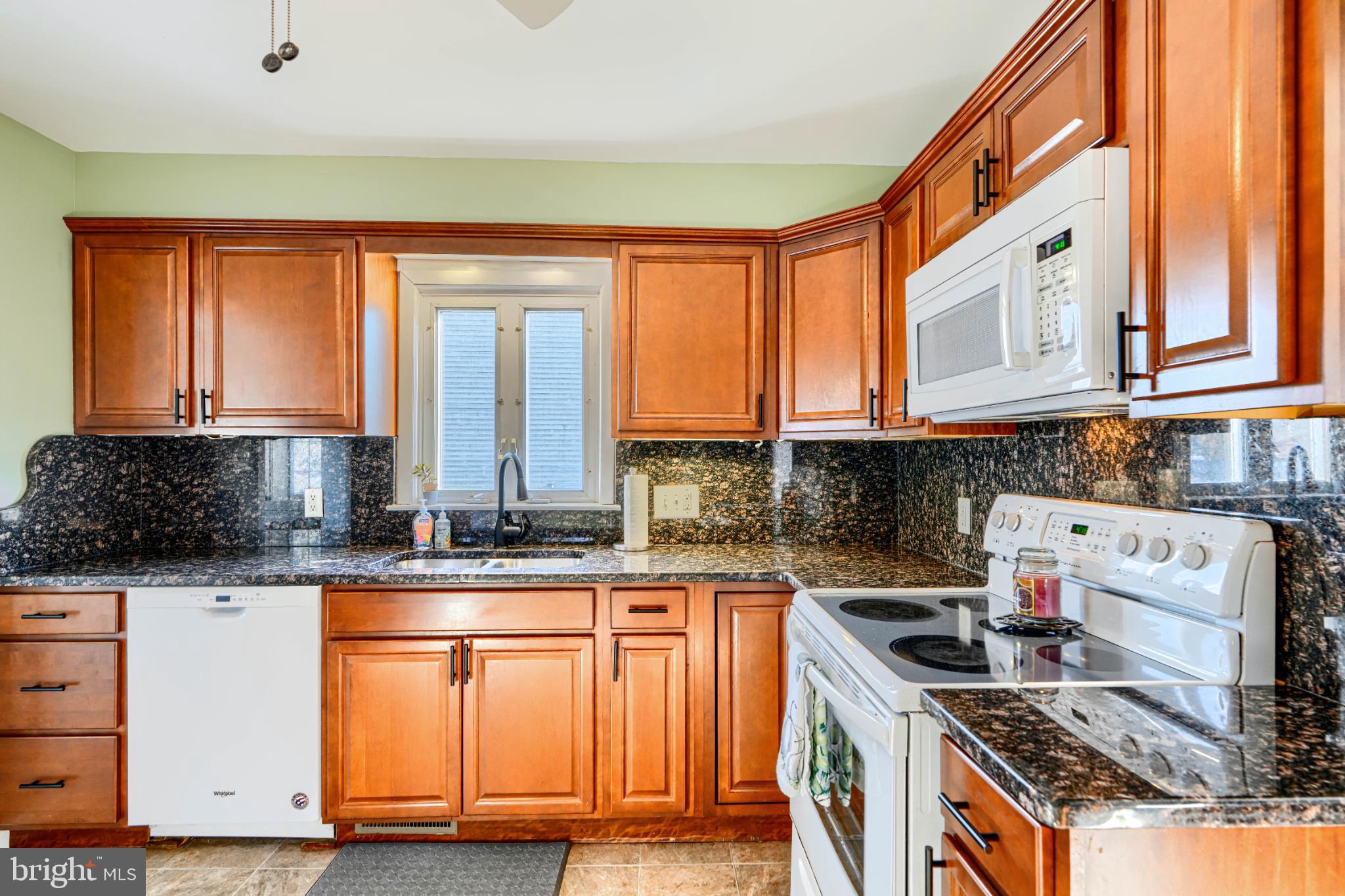 5706 Allender Road White Marsh, MD 21162 - Photo 16 of 61 a kitchen with stainless steel appliances granite countertop a stove a sink and a microwave