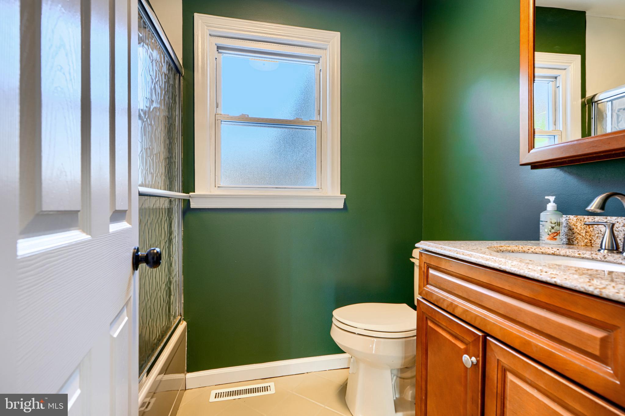 5706 Allender Road White Marsh, MD 21162 - Photo 38 of 61 a bathroom with a toilet sink and mirror