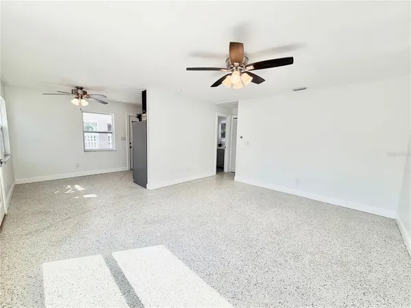 a view of a room with a ceiling fan
