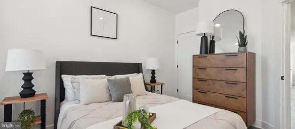 a bedroom with a bed and a mirror