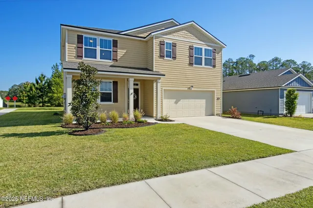 a front view of a house with a yard