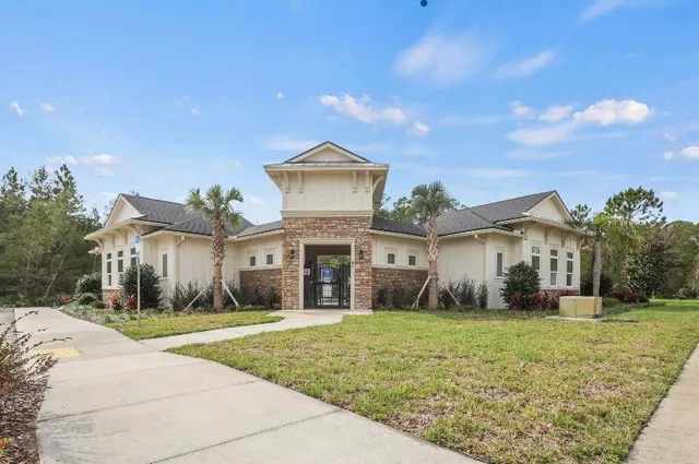 an aerial view of residential houses with outdoor space and swimming pool