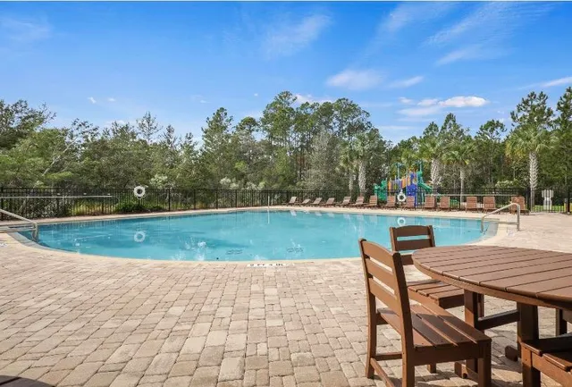 a view of a wooden deck with a house