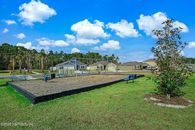 aerial view of residential houses with outdoor space and street view