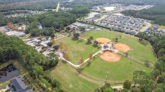 an aerial view of residential houses with outdoor space