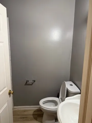 a white toilet sitting next to a small sink