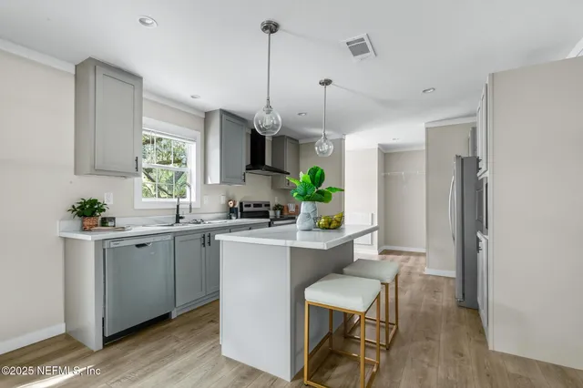 a kitchen with granite countertop white cabinets and a stove