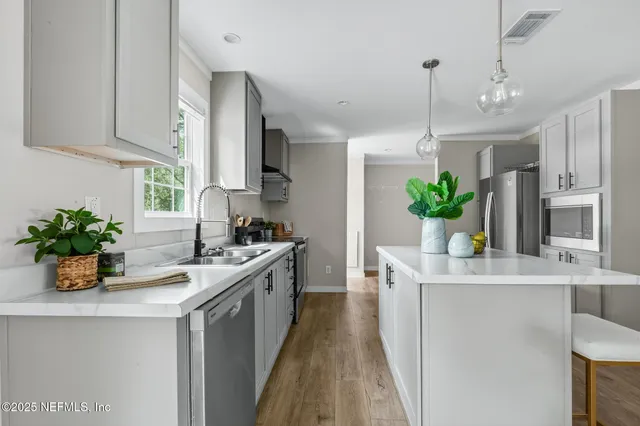 a view of a kitchen with refrigerator and microwave