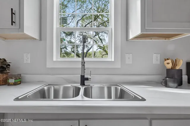a dining room with furniture and potted plants